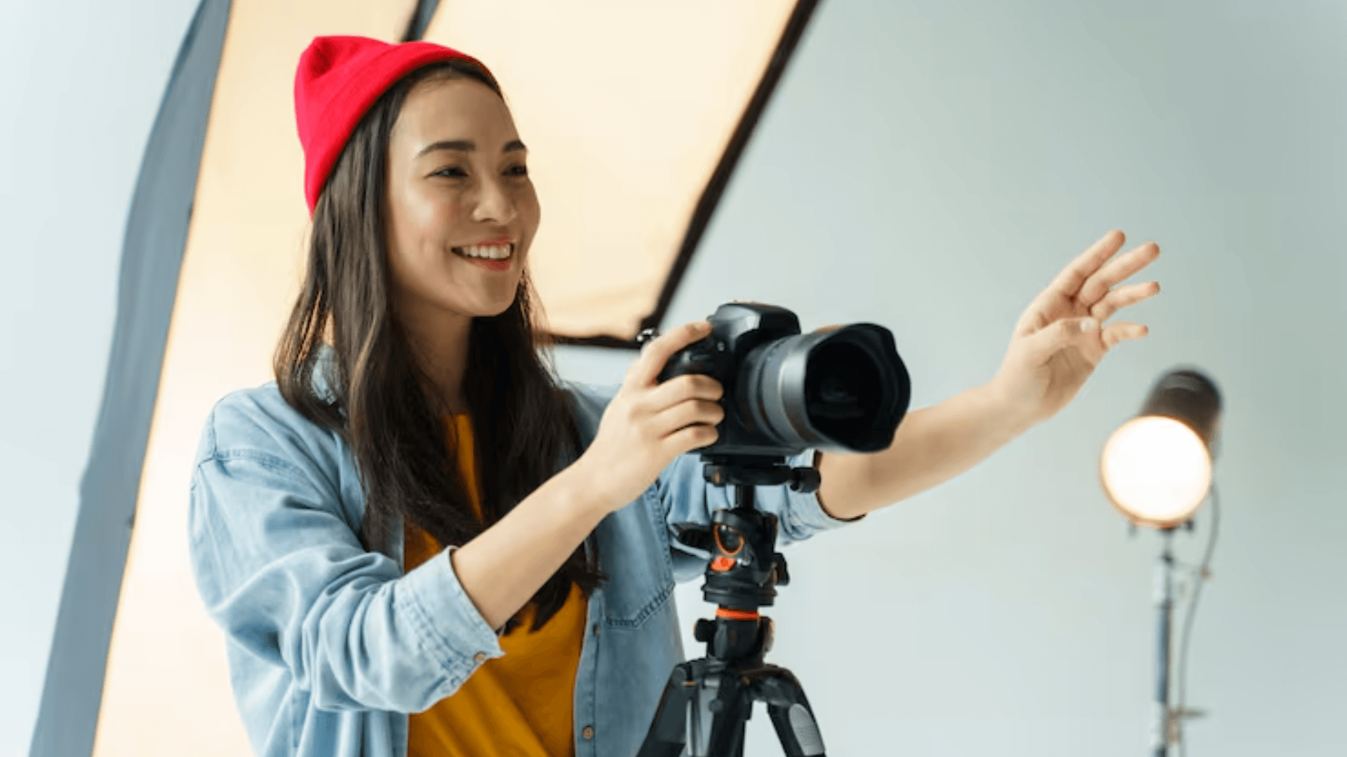 Female photographer adjusting the camera in the studio